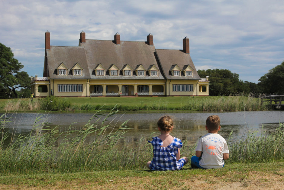 kids sitting and looking at Whalehead Club