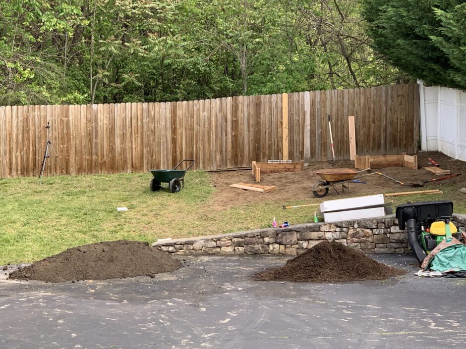 Garden in progress with a pile of soil and mulch