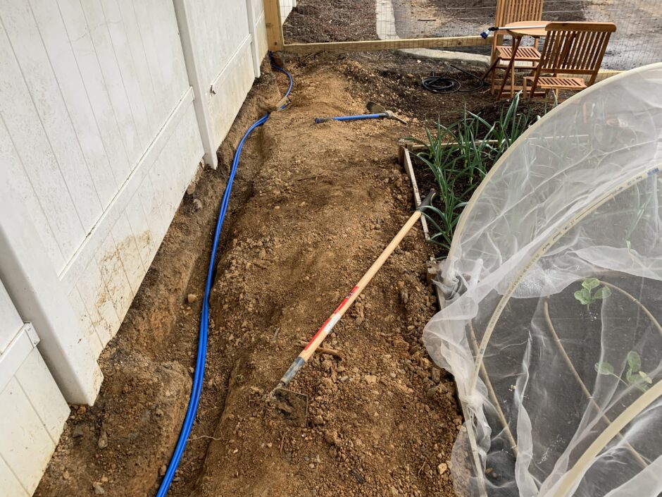 garden irrigation tubing being buried